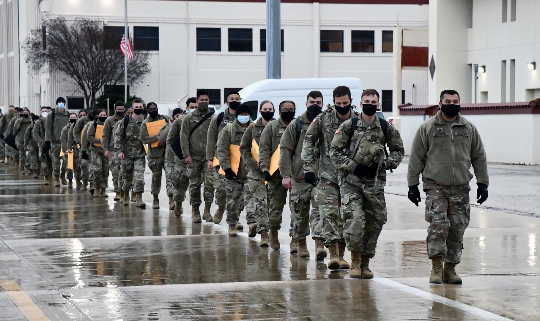 U.S. Army Medical Center of Excellence Advanced Individual Training Soldiers walk in formation at Joint Base San Antonio-Kelly Field Annex before boarding a contract airplane that will take them to their first duty assignment.