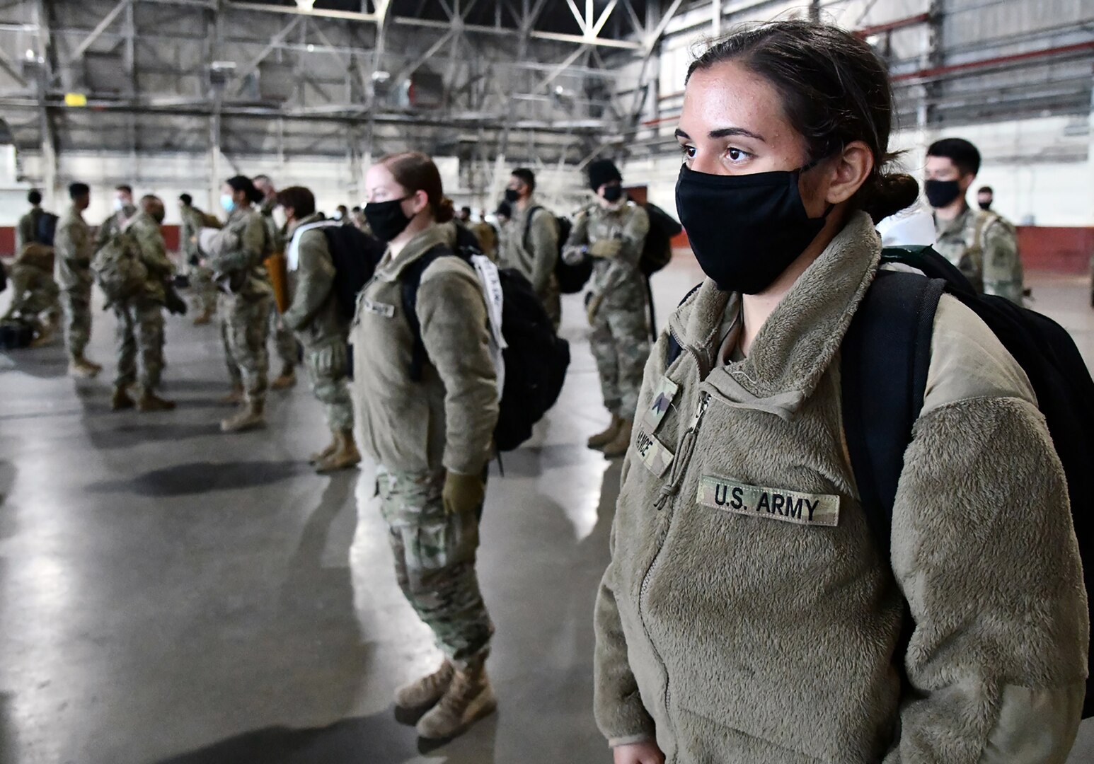 U.S. Army Medical Center of Excellence Advanced Individual Training Soldiers line up in formation at Joint Base San Antonio-Kelly Field Annex before boarding a contract airplane that will take them to their first duty assignment.