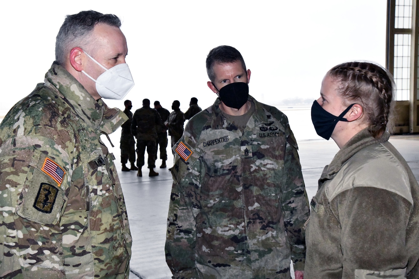 Spc. Angela Thresher (center), a 68W Combat Medic who was identified as the 10,000th Soldier to depart from the U.S. Army Medical Center of Excellence in a controlled manner as part of the COVID-19 pandemic, speaks with Maj. Gen. Dennis LeMaster, MEDCoE commanding general and MEDCoE Command Sgt. Maj. Clark Charpentier.