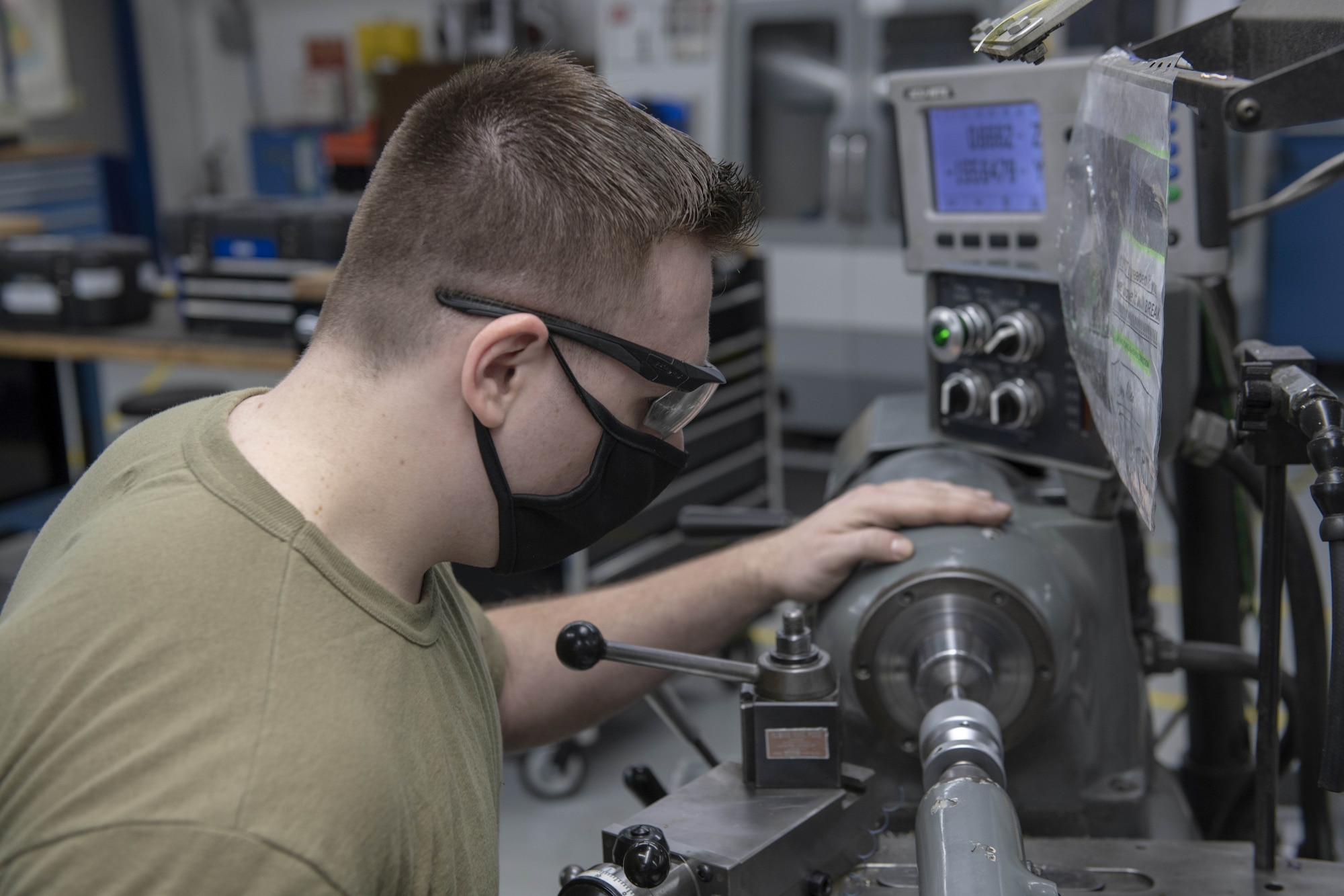 Photo of Airman working with metal.