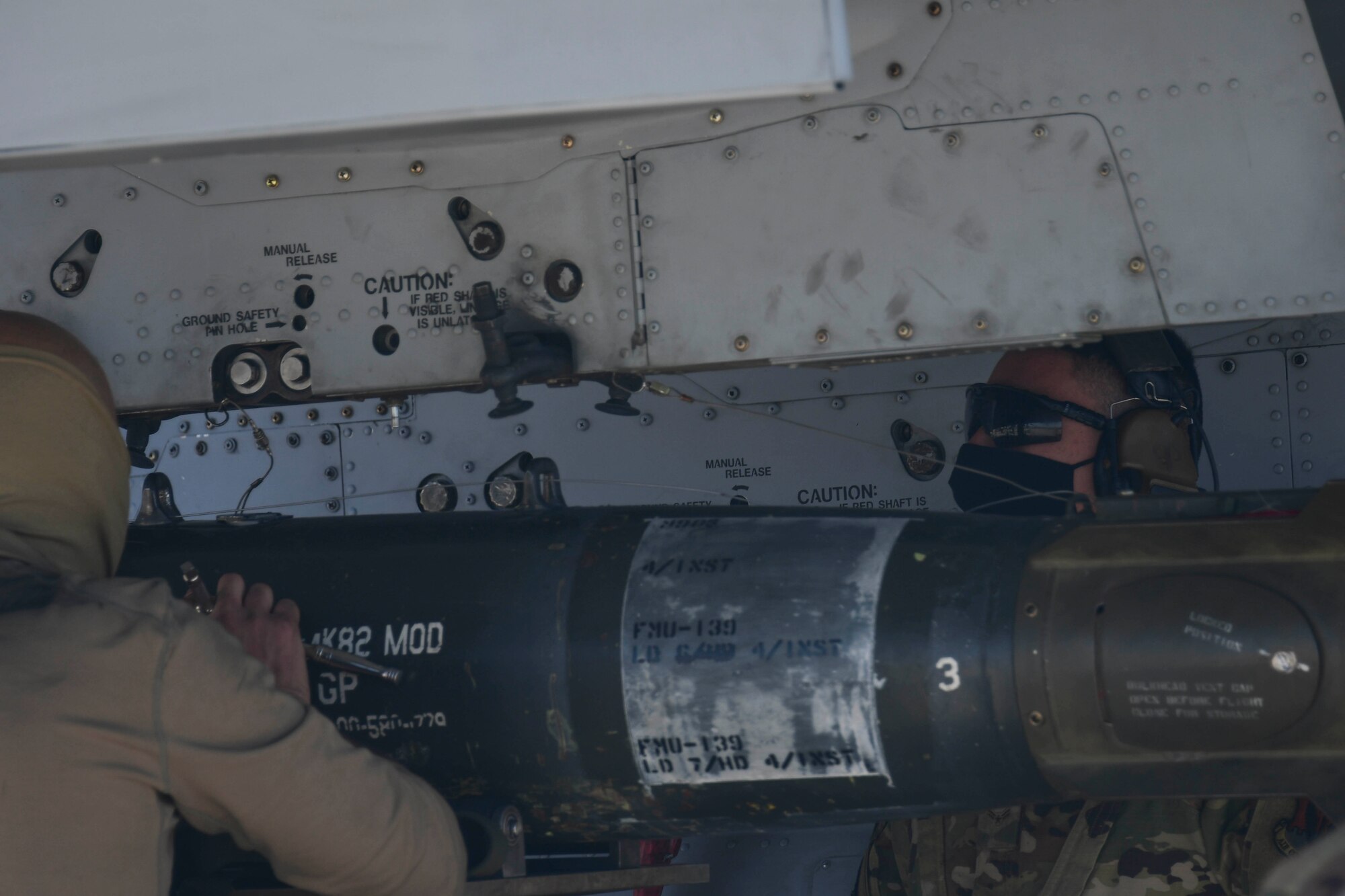 U.S. Air Force Airmen secure munitions to A-10 Thunderbolt II