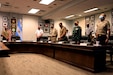 Liaison officers from member nations of the Conference of American Armies stand for the invocation at the opening ceremony at Joint Base San Antonio-Fort Sam Houston, Texas, Feb. 9, 2021. This cycle of the CAA focused on non-commissioned officer development and professionalization as leaders. U.S. Army South plays a key role as the U.S. Army's lead agent and CAA liaison responsible for all coordination with partner nation Armies. (U.S. Army photo by Pfc. Joshua Taeckens)