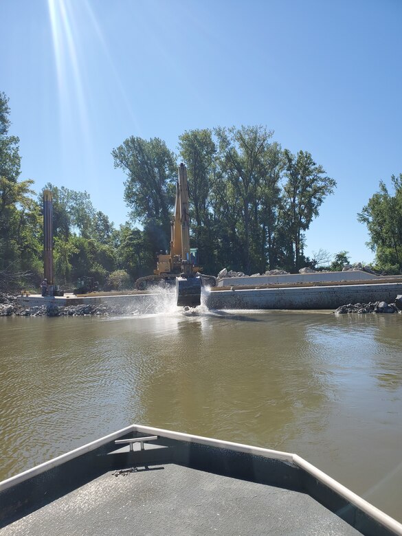 From the prow of a Kansas City District work boat, see Ellis Construction working on a damaged river structure by dropping additional rock to fortify it February 3, 2021, near Glasgow, Mo. on the Missouri River.