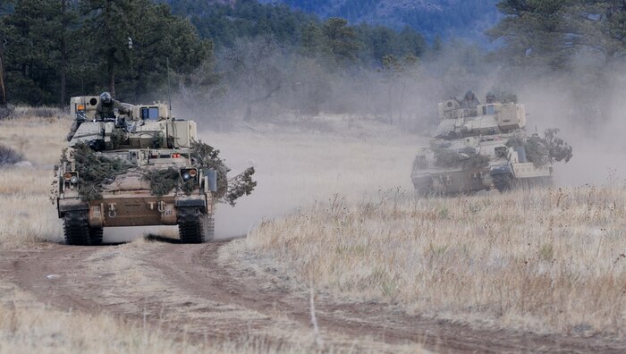 IMAGE: Soldiers of 1st Squadron, 10th Cavalry Regiment, 2nd Brigade Combat Team, 4th Infantry Division drive their M3A3 Bradley Fighting Vehicles to reach a phase line where they will move into a defensive posture during platoon scout training. The Army anticipates that the Intelligent Tracker – a new technological capability developed by a team of Naval Surface Warfare Center Dahlgren Division (NSWCDD) scientists and engineers – will enhance automation for direct fire weapon systems while increasing the speed of operator engagements against targets. The automation applies to a wide range of applications to include the 30mm main gun on a Bradley Fighting Vehicle. (U.S. Army photo by Staff Sgt. Andrew Porch/Released)