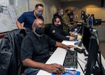 Members of the Joint Base San Antonio Emergency Operations Center perform their duties Feb. 11 at Joint Base San Antonio-Lackland. The EOC has been the command and control hub for emergency operations during the COVID-19 pandemic.