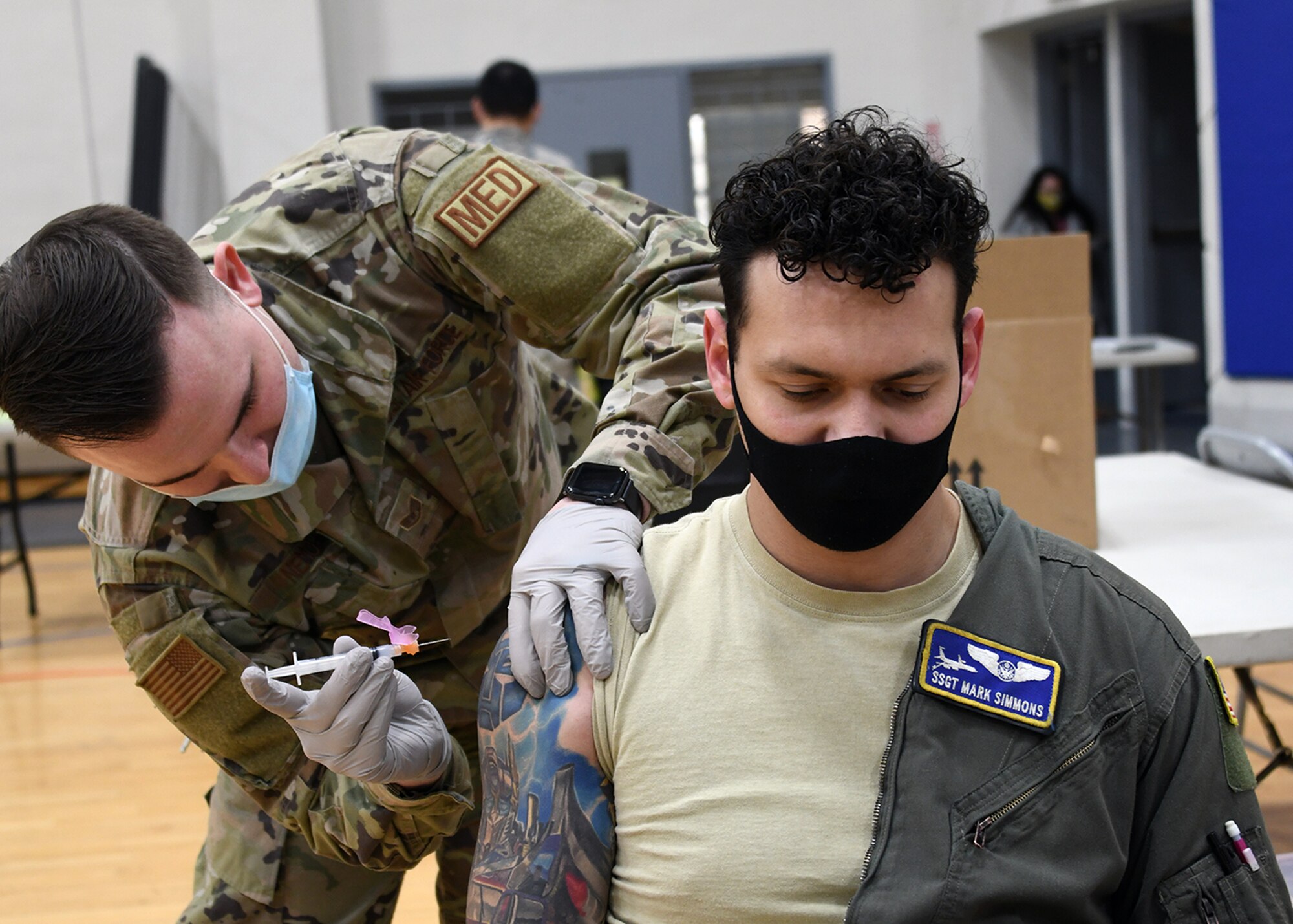 Staff Sgt. Mark Simmons, 459th Air Refueling Squadron boom operator, receives a COVID-19 vaccine from Staff Sgt. Kevin Nemo, 459th Aerospace Medicine Squadron medical technician, Feb. 10th, 2021, at Joint Base Andrews, Md. Simmons was among the first group of Airmen to receive the vaccine in the wing. (U.S. Air Force photo by Staff Sgt. Cierra Presentado/Released)