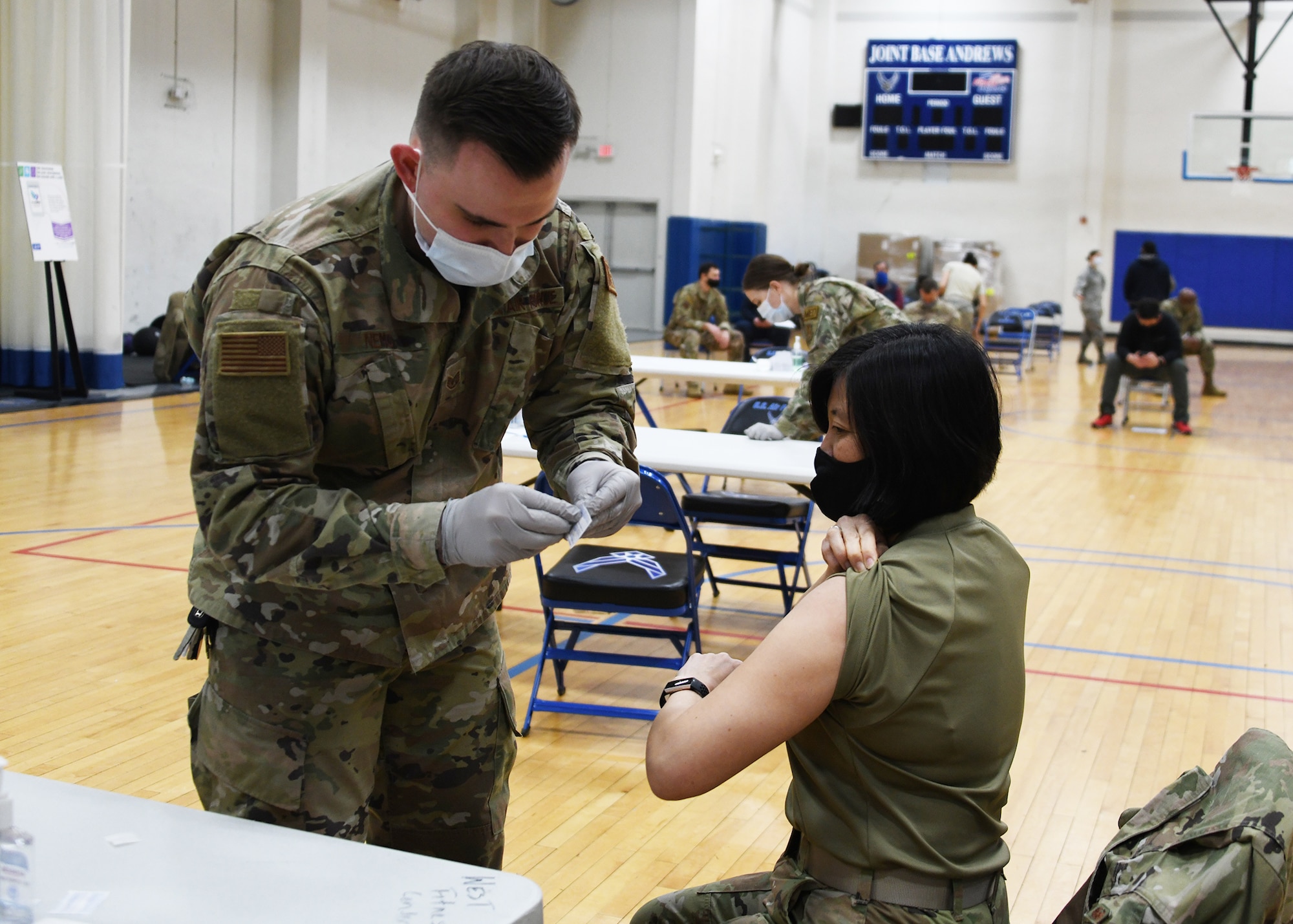 Col. Janet Thode, 459th Air Refueling Wing vice wing commander, receives the COVID-19 vaccine from Staff Sgt. Kevin Nemo, 459th Aerospace Medicine Squadron medical technician Feb. 10th, 2021 at Joint Base Andrews, Md. The wing is now administering the vaccine to Airmen and DoD civilians. (U.S. Air Force photo by Staff Sgt. Cierra Presentado/Released)