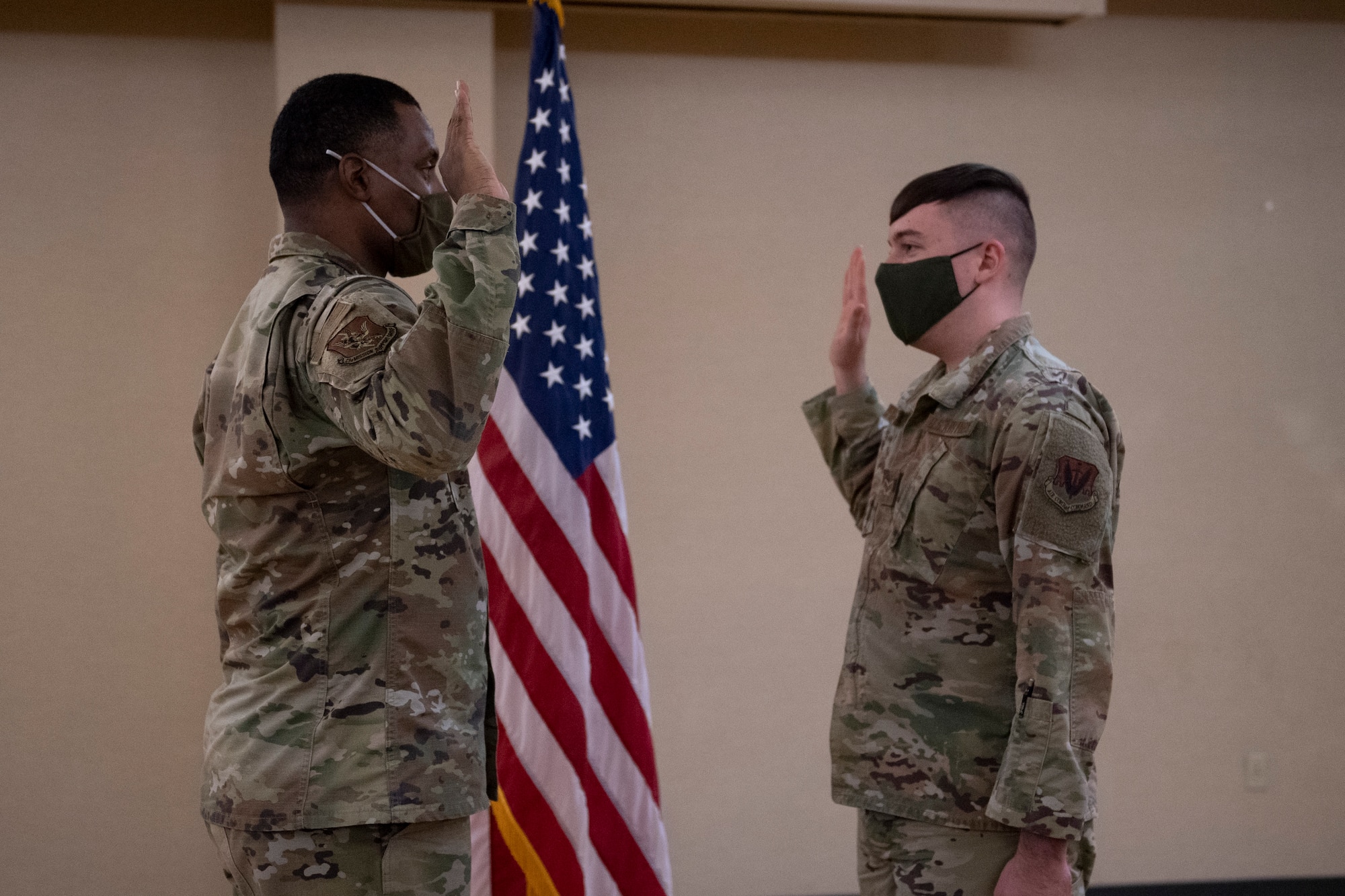 A photo of two Airmen raising their right hands during an enlistment.