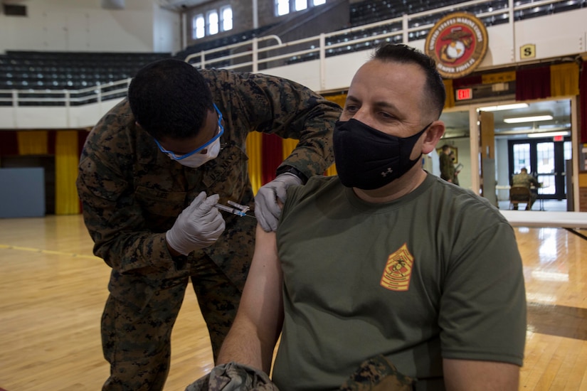 A man gets an injection in his arm.