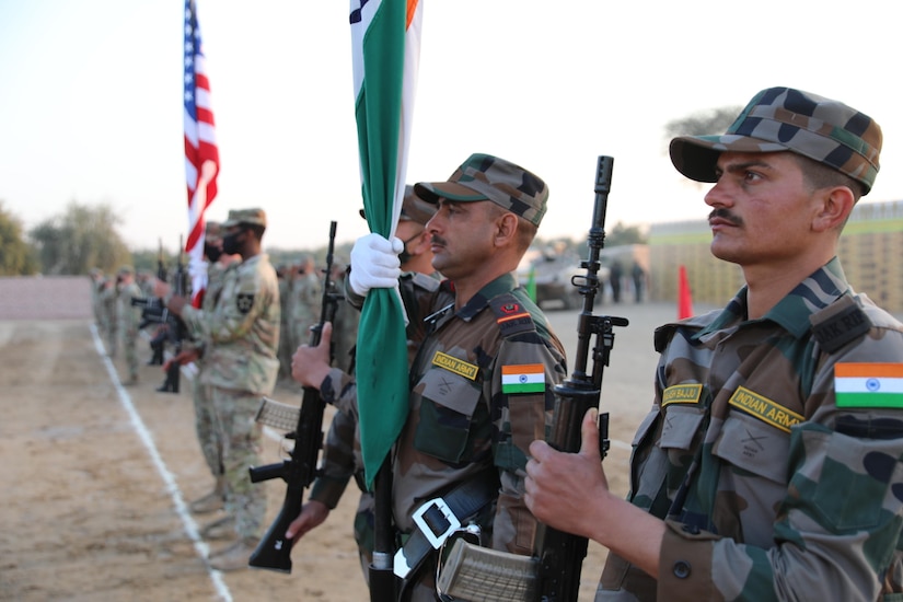 Military service members stand in formation.