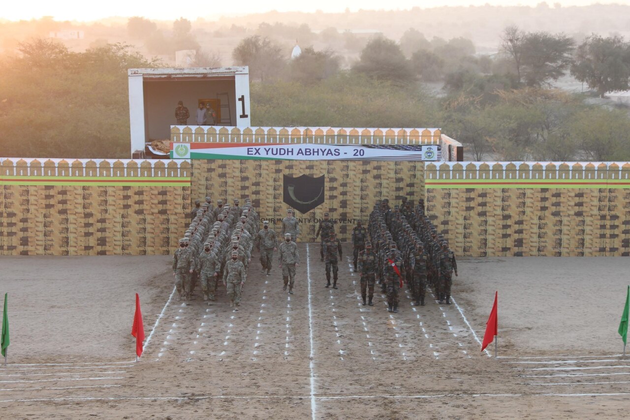 Service members stand in formation.