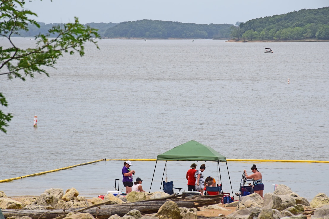 Visitors under canopy at beach