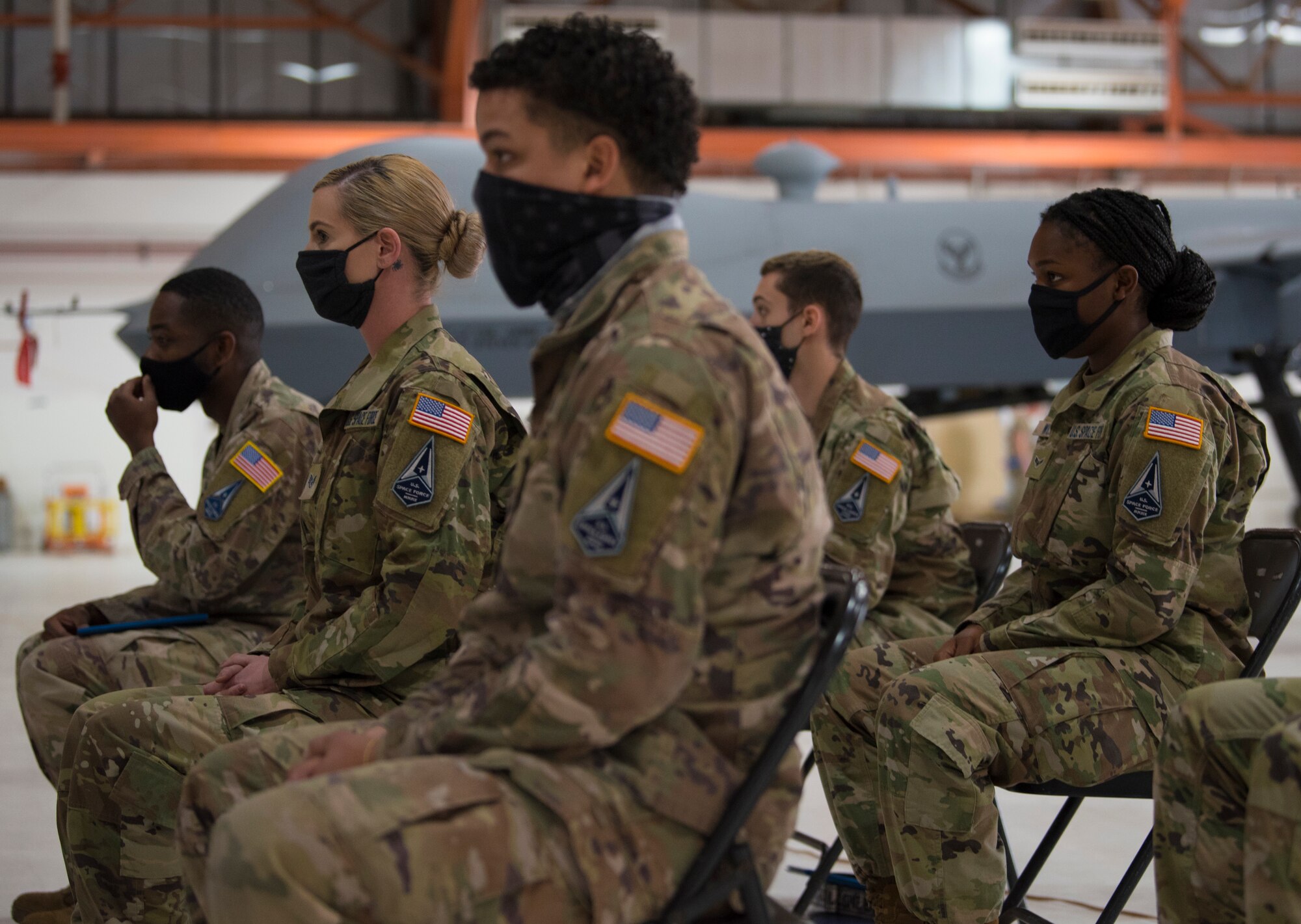 New U.S. Space Force Guardians sit during a U.S. Space Force transfer ceremony, Feb. 12, 2021, on Holloman Air Force Base, New Mexico. During the ceremony, transitioning Airmen took the Oath of Office and Oath of Enlistment to officially transfer over as Guardians to the Space Force. (U.S. Air Force photo by Airman 1st Class Jessica Sanchez)