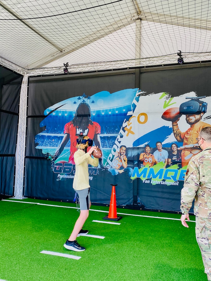 A young fan prepared to throw the football while using the Air Force’s AIR RAID QB SIM Experience at the Super Bowl LV experience outside of Raymond James Stadium in Tampa, Florida, Jan. 31, 2021.