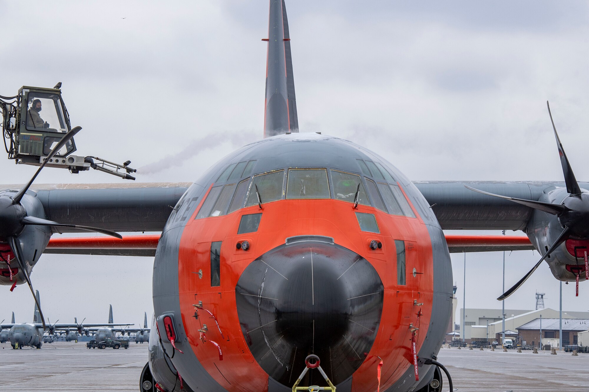 An Airman from the 19th AMXS de-ices the top of a C-130J Super Hercules.