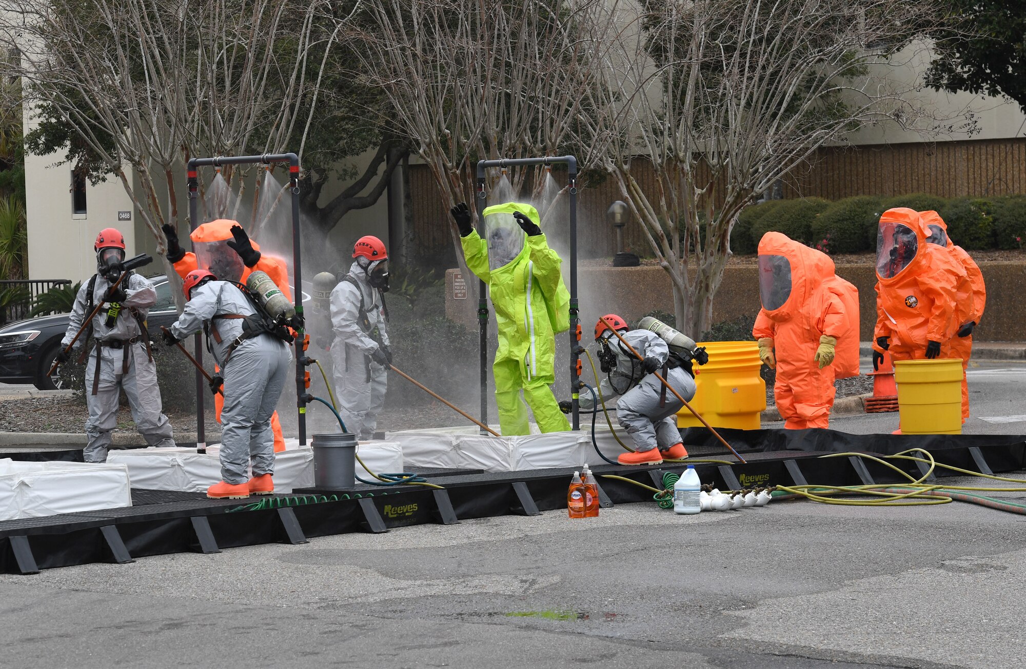 Emergency response team members walk through a decontamination line outside the Keesler Medical Center at Keesler Air Force Base, Mississippi, Feb. 11, 2021. Members of the Keesler Fire Department, 81st Security Forces Squadron, 81st Medical Group and Emergency Management responded to a suspicious package found inside the Keesler Medical Center. (U.S. Air Force photo by Kemberly Groue)