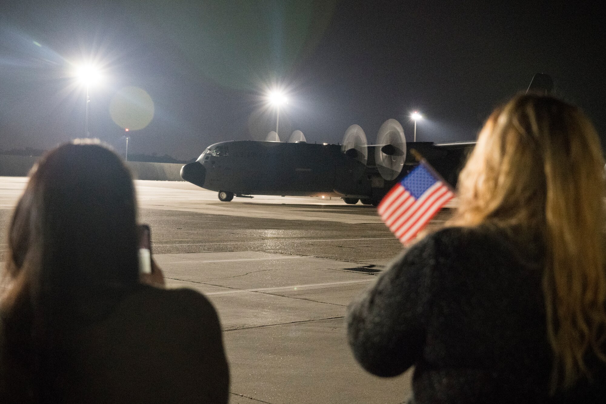 Family members await the return of their Reserve Citizen Airmen to Keesler Air Force Base, Mississippi, Feb. 10, 2021. Airmen from the 815th Airlift Squadron and maintenance and personnel from throughout the 403rd Wing were deployed to Southwest Asia where they supported Operations Freedom Sentinel and Inherent Resolve. (U.S. Air Force photo by 2nd Lt. Christopher Carranza)