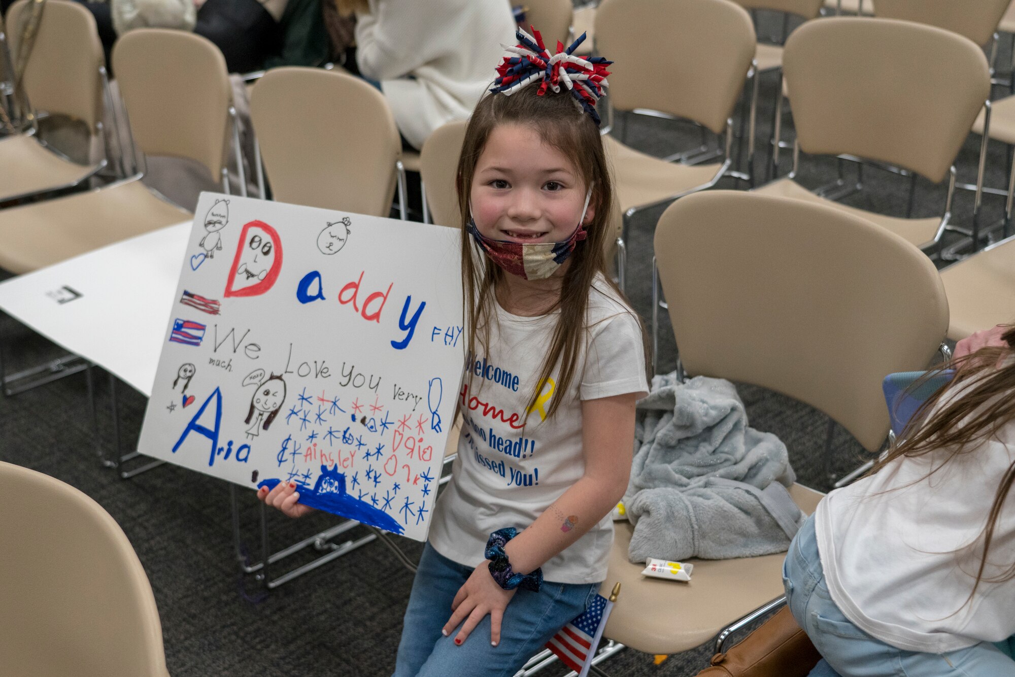 Family members await the return of their Reserve Citizen Airmen to Keesler Air Force Base, Mississippi, Feb. 13, 2021. Airmen from the 815th Airlift Squadron and maintenance and personnel from throughout the 403rd Wing were deployed to Southwest Asia where they supported Operations Freedom Sentinel and Inherent Resolve. (U.S. Air Force photo by 2nd Lt. Christopher Carranza)