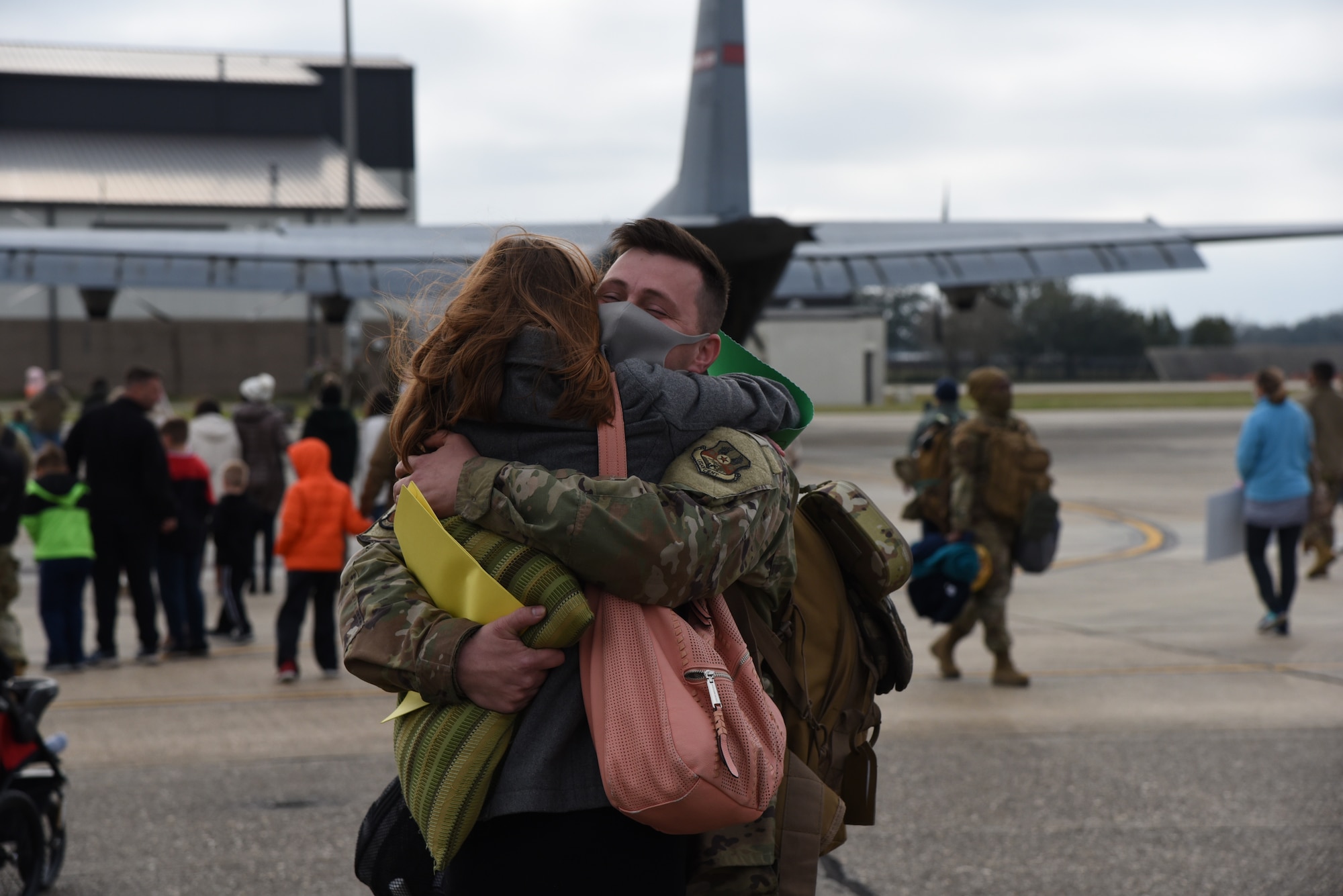 Family members await the return of their Reserve Citizen Airmen to Keesler Air Force Base, Mississippi, Feb. 13, 2021. Airmen from the 815th Airlift Squadron and maintenance and personnel from throughout the 403rd Wing were deployed to Southwest Asia where they supported Operations Freedom Sentinel and Inherent Resolve. (U.S. Air Force photo by Lt. Col. Marnee A.C. Losurdo)