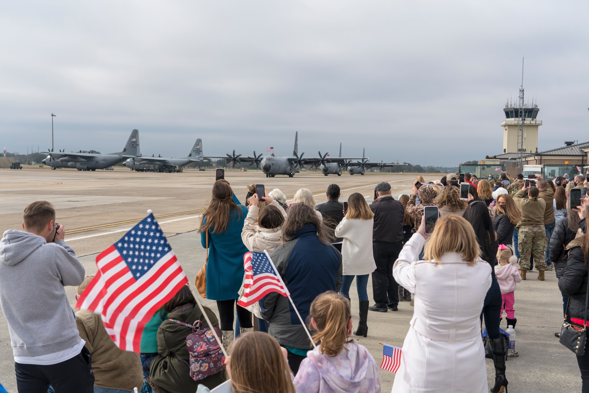 Family members await the return of their Reserve Citizen Airmen to Keesler Air Force Base, Mississippi, Feb. 13, 2021. Airmen from the 815th Airlift Squadron and maintenance and personnel from throughout the 403rd Wing were deployed to Southwest Asia where they supported Operations Freedom Sentinel and Inherent Resolve. (U.S. Air Force photo by 2nd Lt. Christopher Carranza)