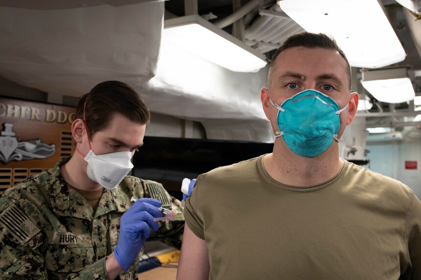 Sailors receive the COVID-19 vaccine aboard USS Mitscher (DDG 57).