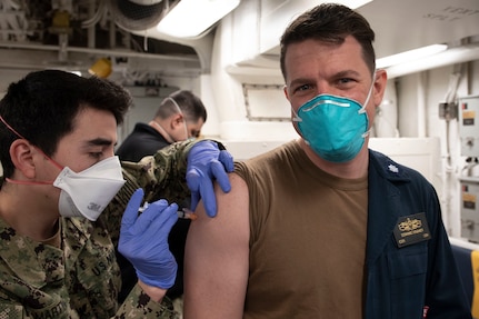 Sailors receive the COVID-19 vaccine aboard USS Mitscher (DDG 57).