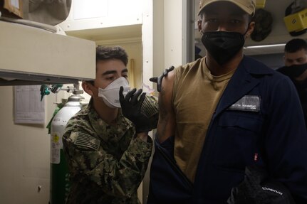 Sailors receive the COVID-19 vaccine aboard USS Mahan (DDG 72).