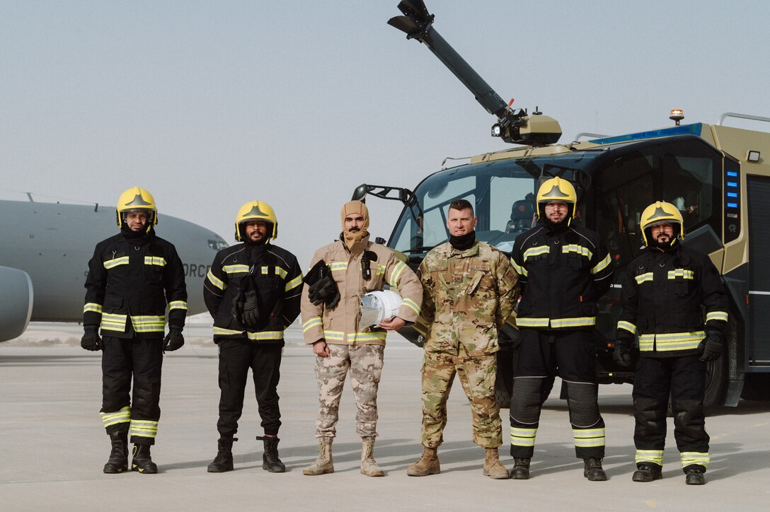 firefighters pose on runway