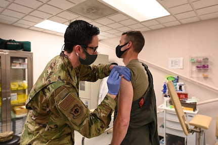U.S. Air Force Staff Sgt. Matthew Hartwig, 173rd Medical Group, administers the COVID-19 vaccine to Col. Jeff Edwards, 173rd Fighter Wing commander, Feb. 12, 2021, at Kingsley Field in Klamath Falls, Oregon. About 100 doses of the vaccine were administered to volunteer members of the Oregon National Guard.