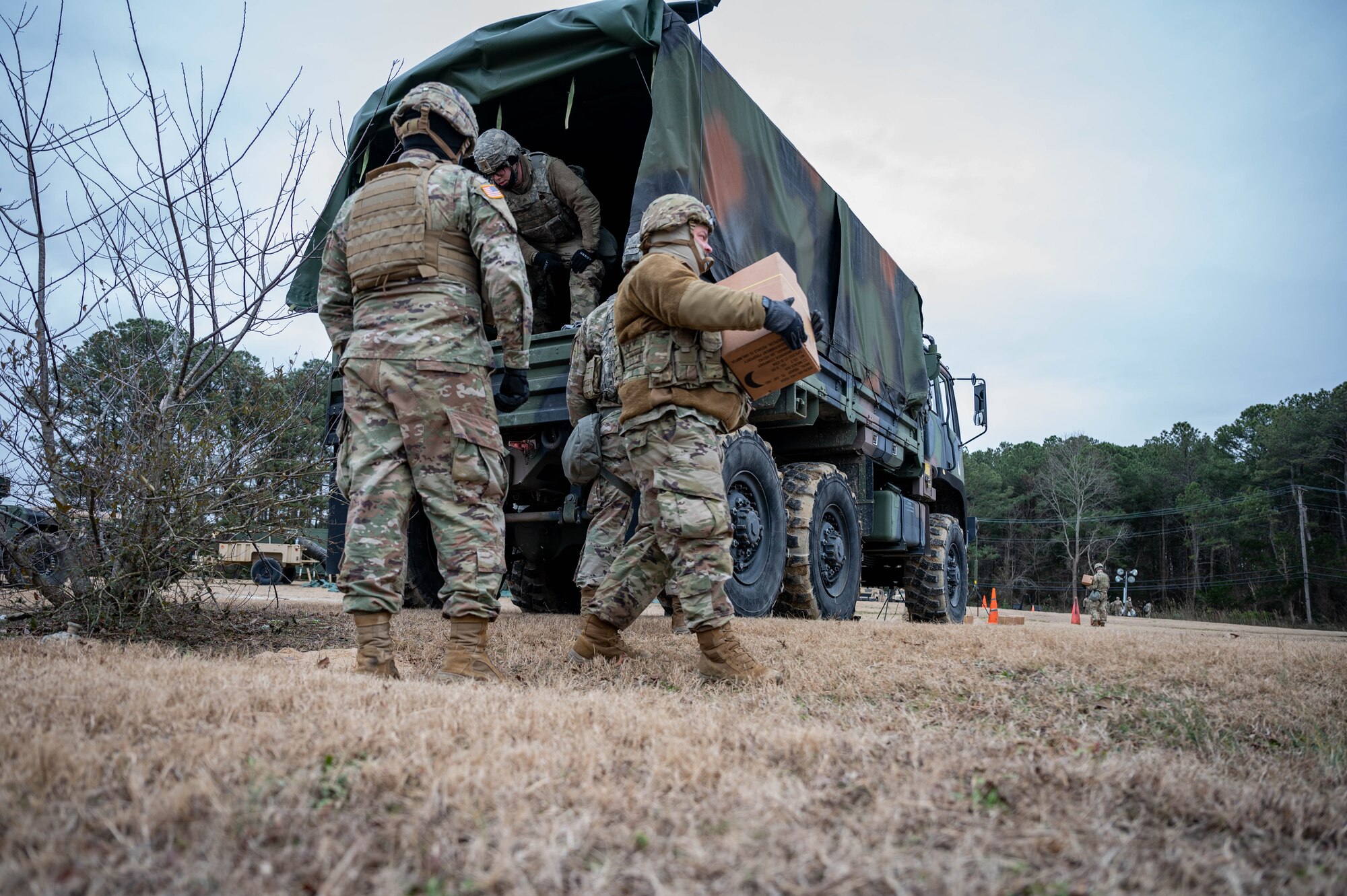 Soldiers unload a truck.