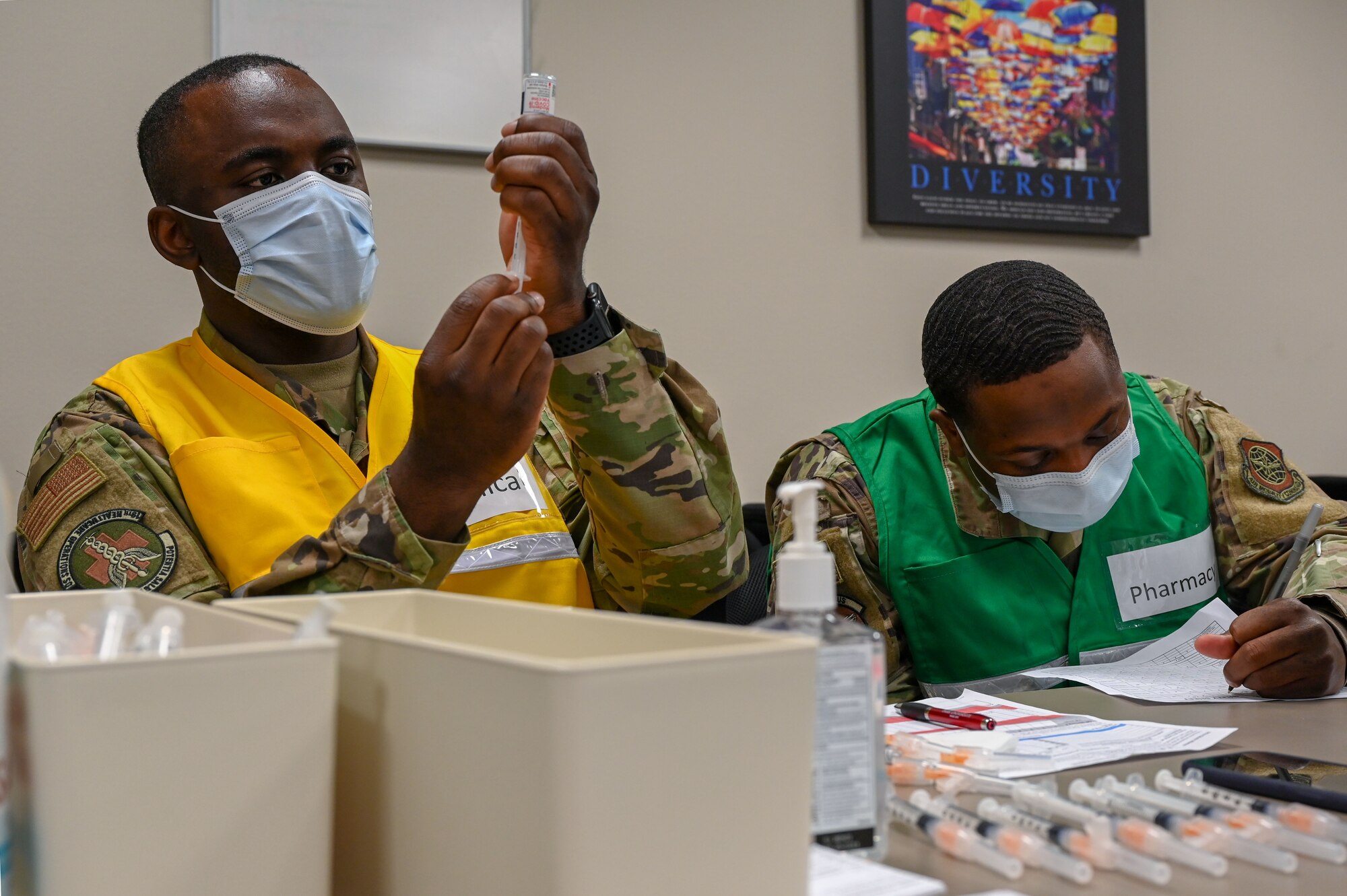 A technician fills a syringe