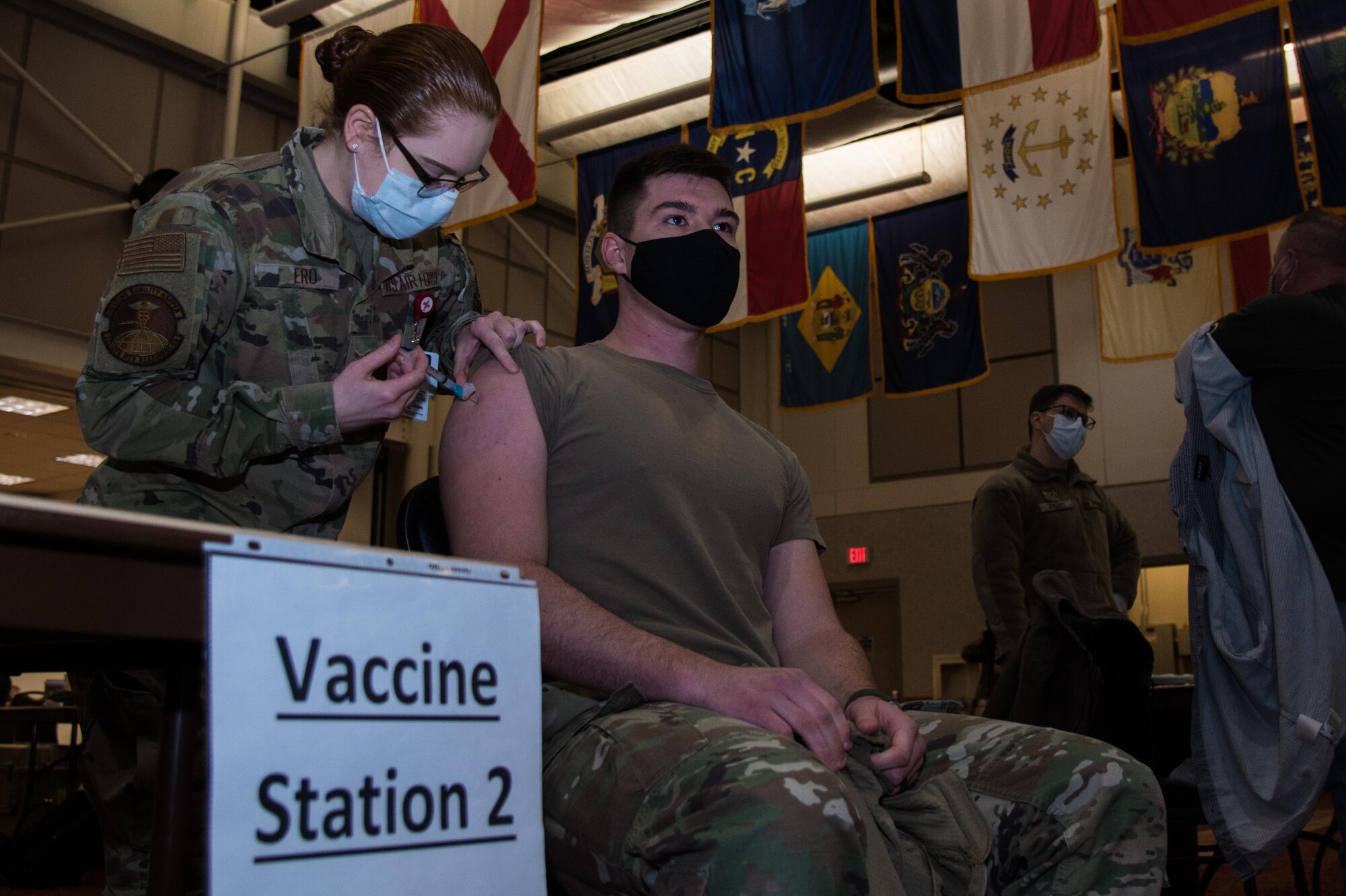 2nd Lt. Houston Anderson, 22nd Civil Engineer Squadron deputy chief engineering flight, receives his first round of the COVID-19 vaccine from Airman 1st Class Rhiannon Ero, 22nd Operational Medical Readiness Squadron medical technician, Feb. 9, 2021, at McConnell Air Force Base, Kansas. The vaccine is currently voluntary for all Department of Defense personnel, including active duty, Guard/Reserve, retirees, family members, civilian employees and selected DOD contracted personnel. (U.S. Air Force photo by Senior Airman Alexi Bosarge)
