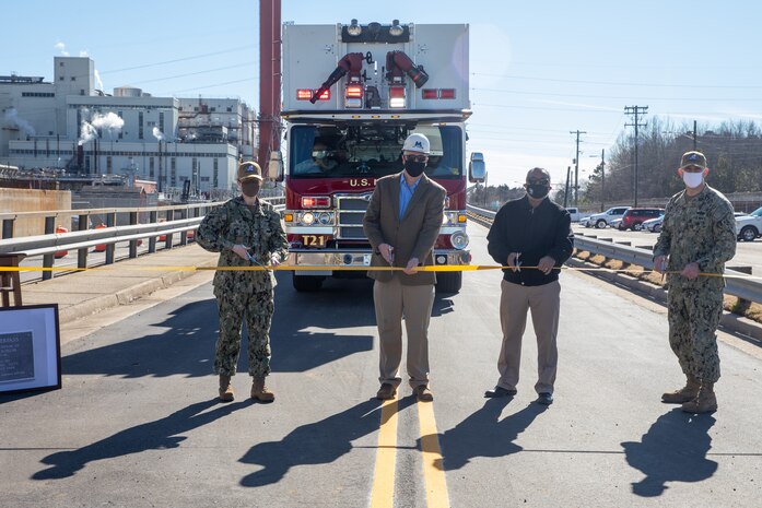 On Feb. 4, Norfolk Naval Shipyard (NNSY) Commander, Captain Dianna Wolfson,  Stan Magann, President, WF Magann Corp.,  Ananth Badrinath, Director, Desbuild Inc, and Captain Bill Butler, NNSY’s Public Works Officer, prepare to cut the ribbon during a ribbon cutting ceremony celebrating the completion of the $6,460,230 Borum Overpass restoration project.