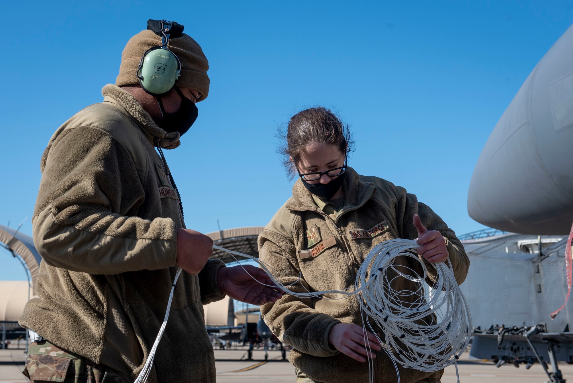 Airman 1st Class Quentin Thompson (left) and Senior Airman Kierra Hamil (right), 4th Component Maintenance Squadron electrical and environmental technicians, organize and lay out test harnesses at Seymour Johnson Air Force Base, North Carolina, Feb. 3, 2021.