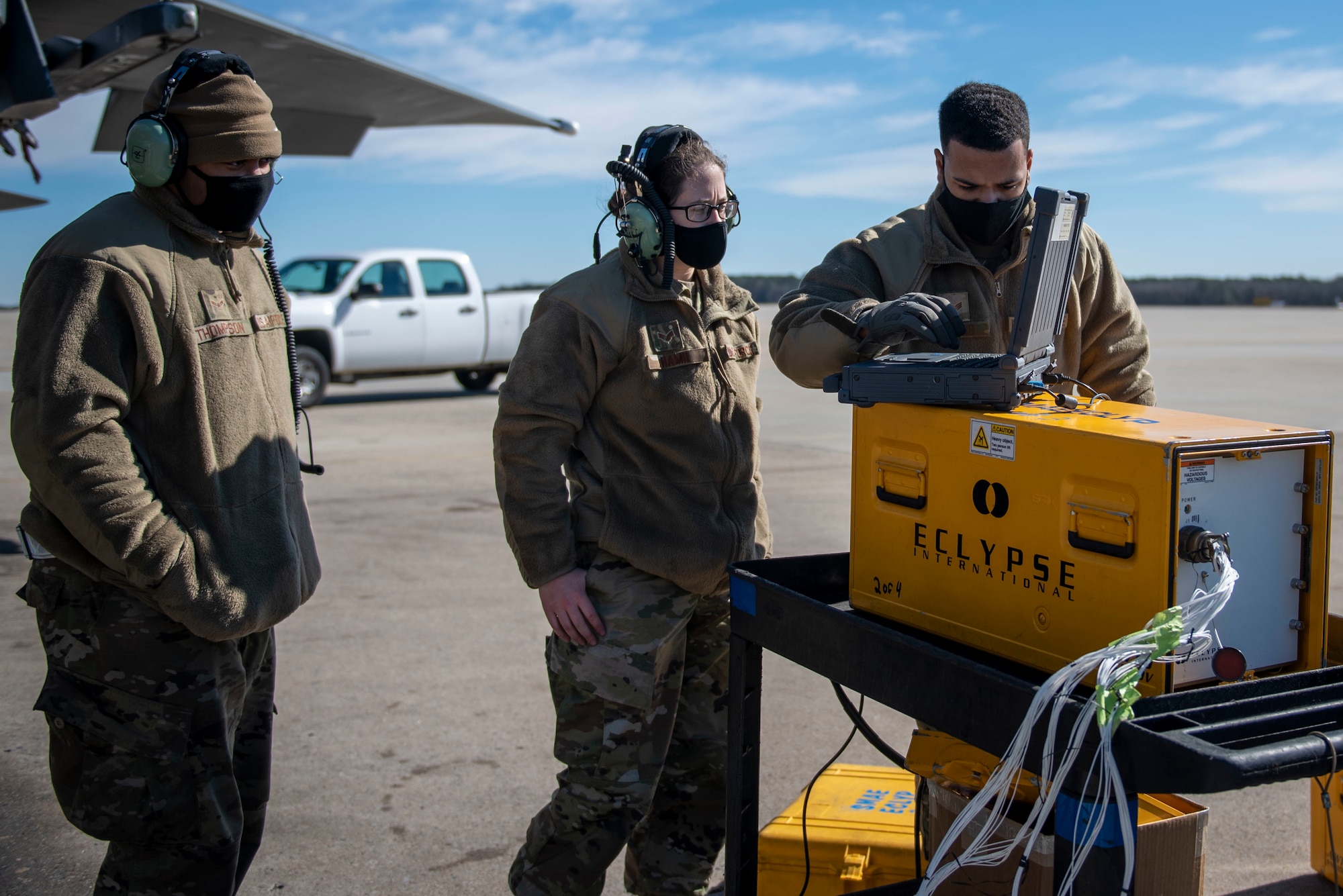 Airman 1st Class Quentin Thompson (left) and Senior Airman Kierra Hamil (middle), 4th Component Maintenance Squadron electrical and environmental technicians, and Senior Airman Thiago Santos (right), 4th Fighter Readiness Squadron electronics technician, start the Eclypse tester and run a program to test an F-15E Strike Eagle’s pod system and wiring at Seymour Johnson Air Force Base, North Carolina, Feb. 3, 2021.