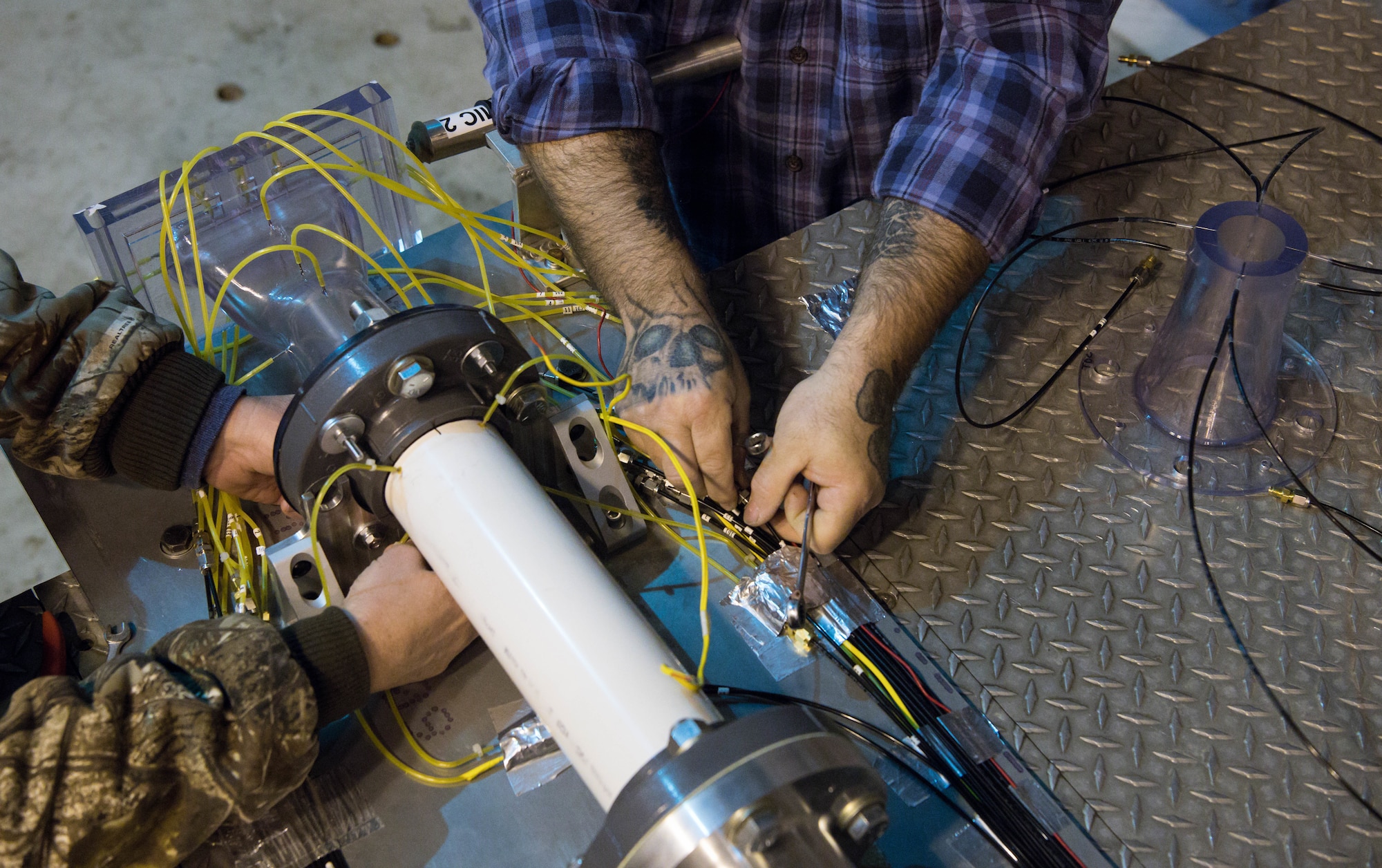 Arnold Engineering Development Complex Propulsion Test Branch team members disconnect instrumentation as they prepare to change out test articles in the Sea Level 2 Test Cell, Dec. 17, 2020, at Arnold Air Force Base, Tenn. (U.S. Air Force photo by Jill Pickett)