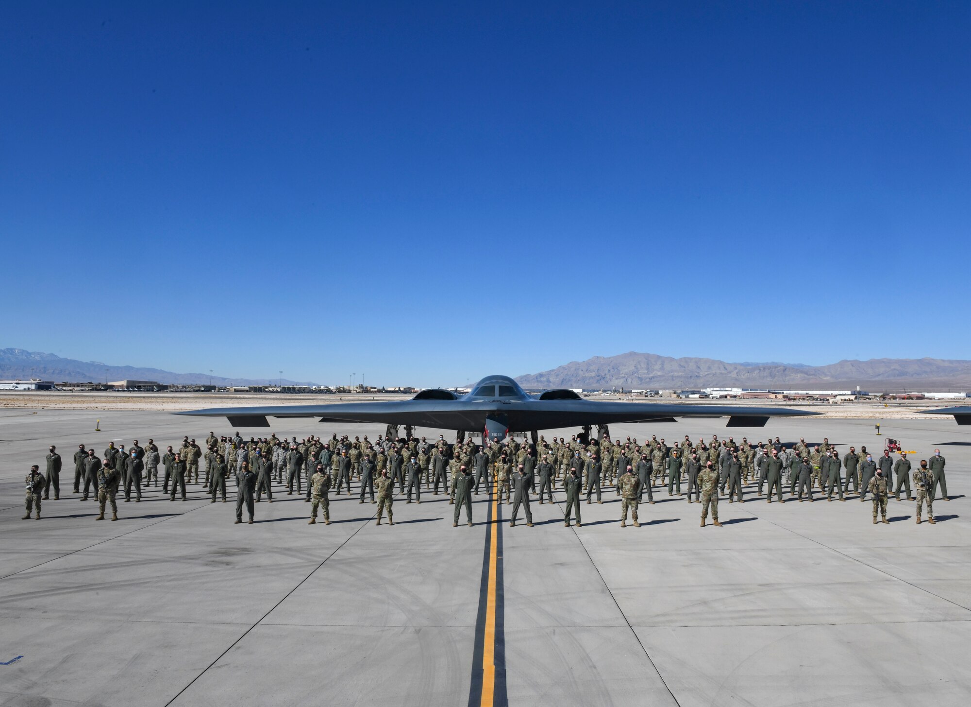 Multiple 393rd Expeditionary Bomb Squadron Airmen stand for a group photo during Red Flag 21-1, Feb. 6, 2021, at Nellis Air Force Base, Nevada. Along with aircrew, approximately 100 Team Whiteman Airmen participated in the large-force exercise as the lead wing. As the lead wing, RF 21-1 enabled Team Whiteman Airmen to maintain a high state of readiness and proficiency, while validating their always-ready global strike capability. (U.S. Air Force photo by Staff Sgt. Sadie Colbert)