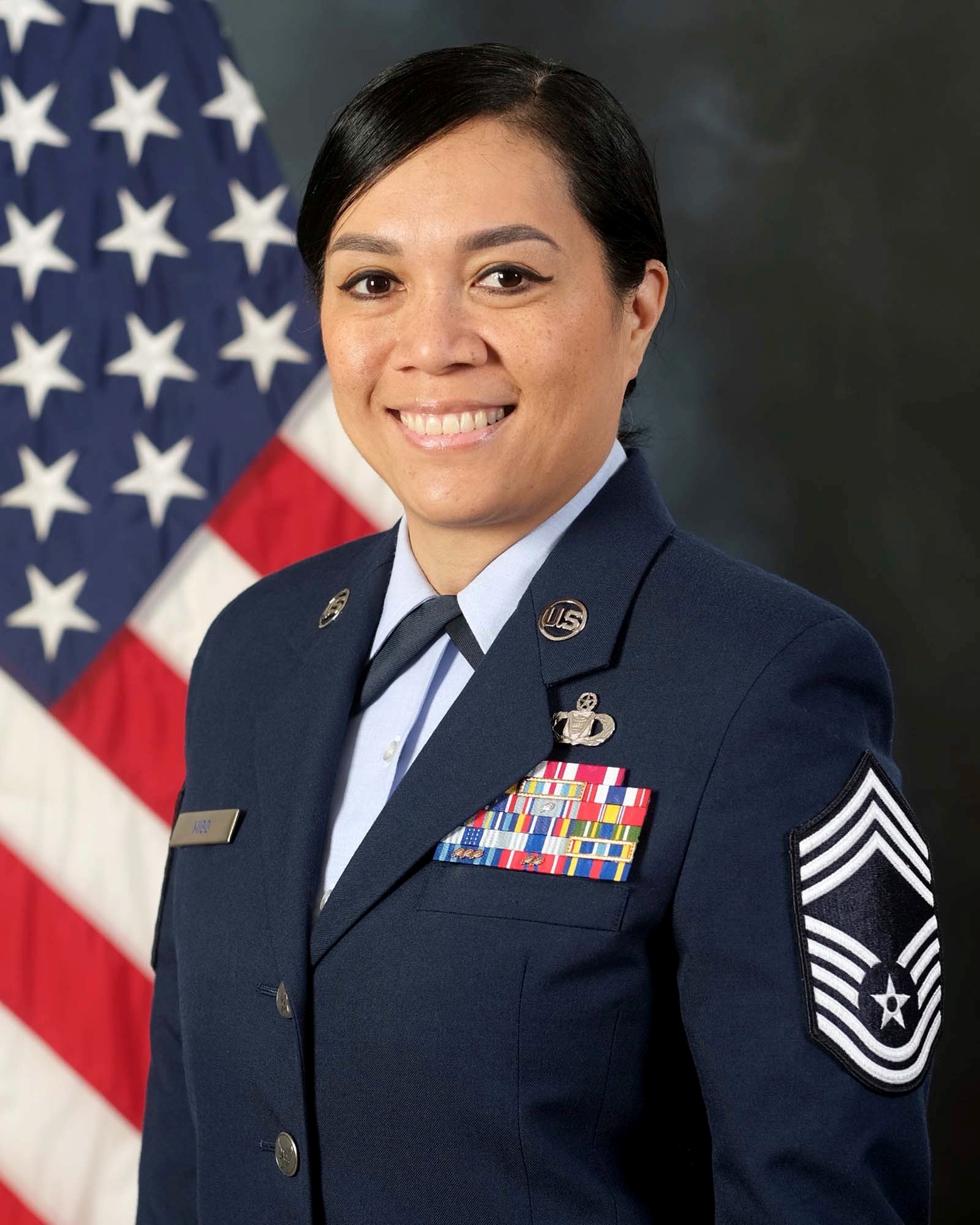 photo official photo of Chief Migo with U.S. Flag in background