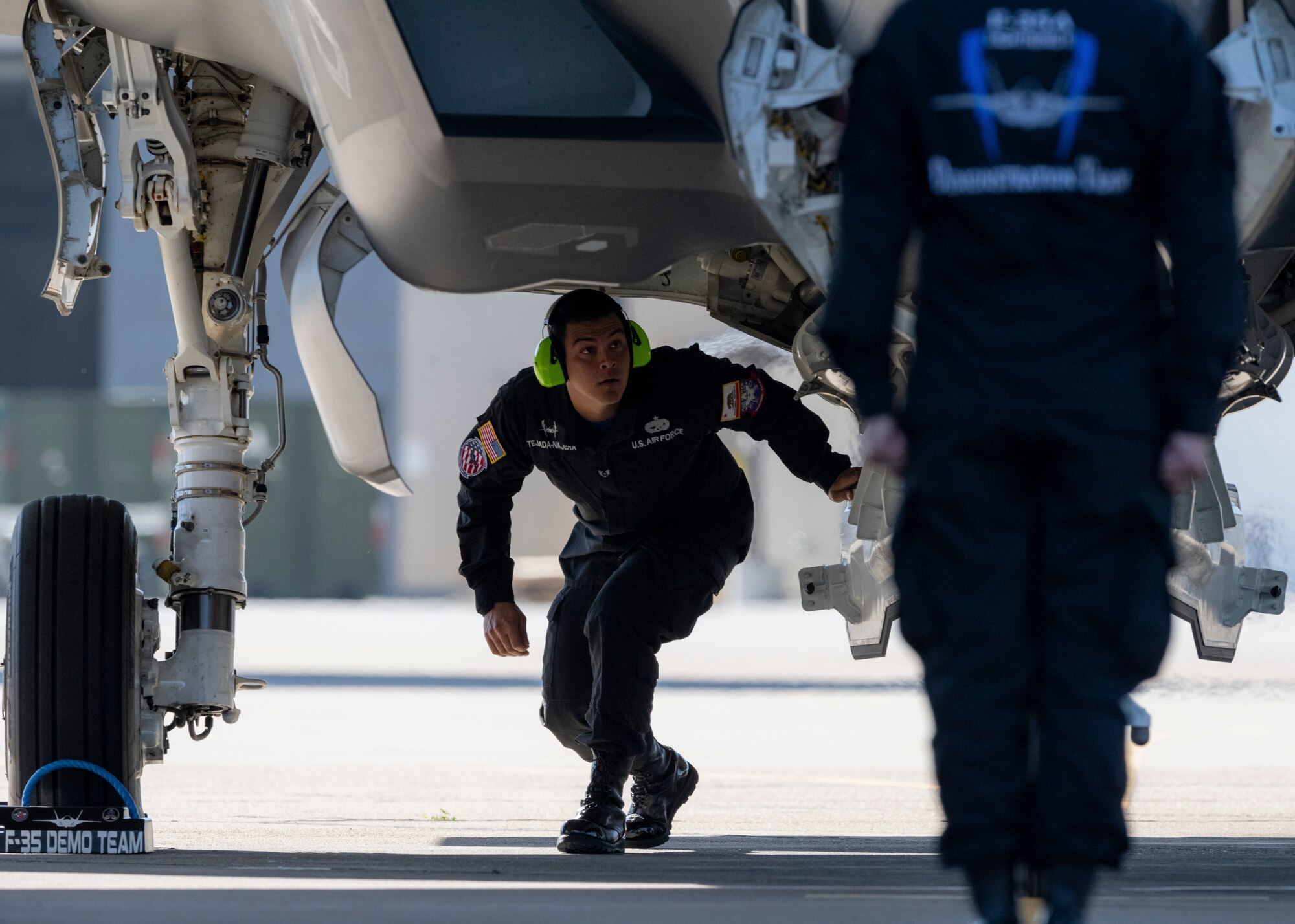 A maintainer inspects an F-35