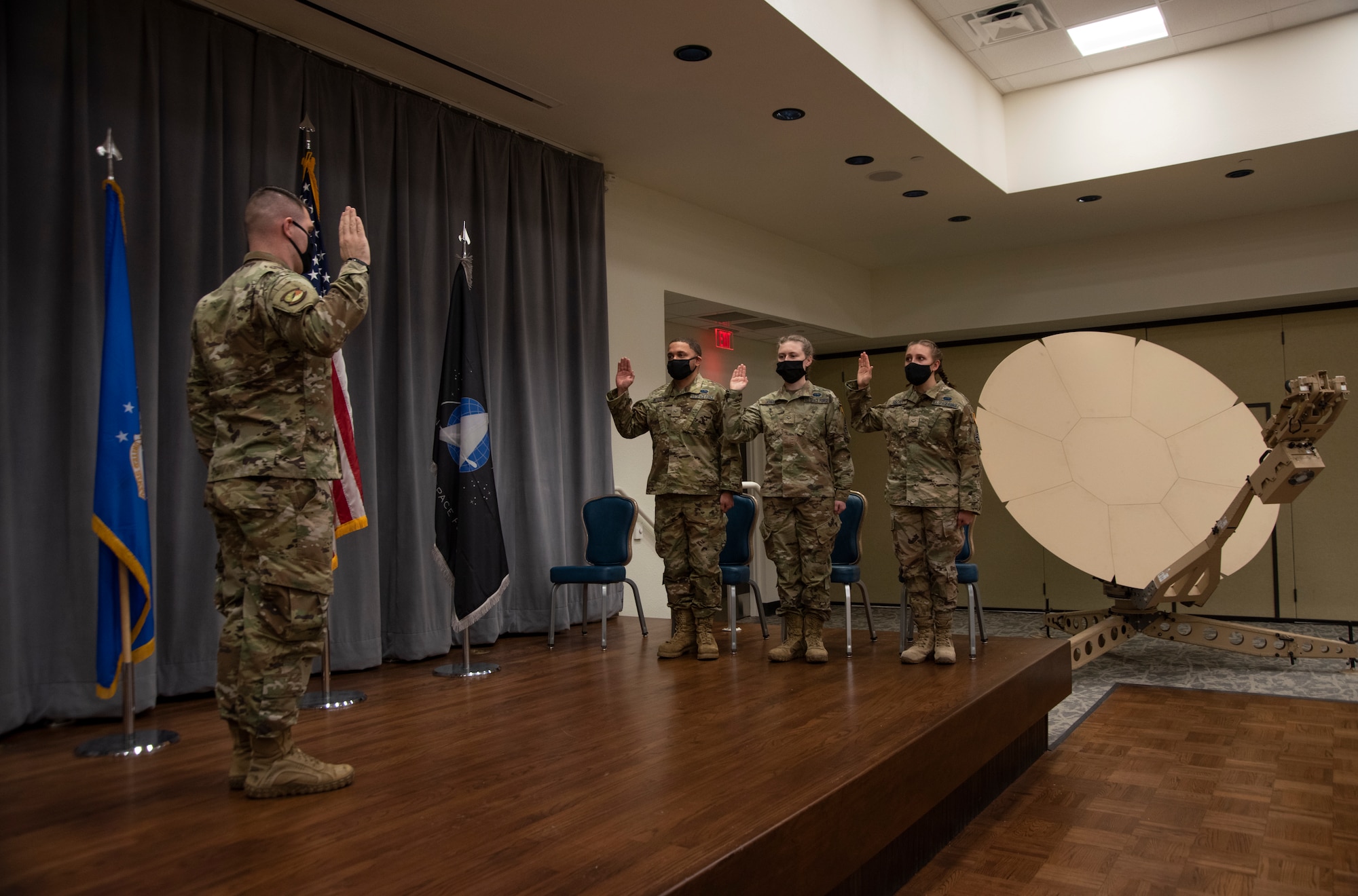 U.S. Space Force Capt. Sean Nuttall swears in the former Airmen into U.S. Space Force Guardians.
