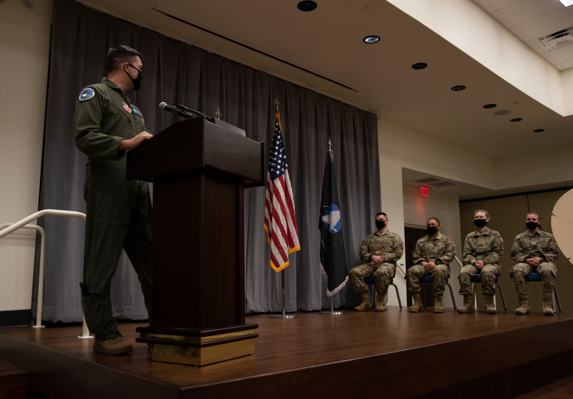 One Airman officer looks at new Guardians and congratulates them on their transfer to the U.S. Space Force.