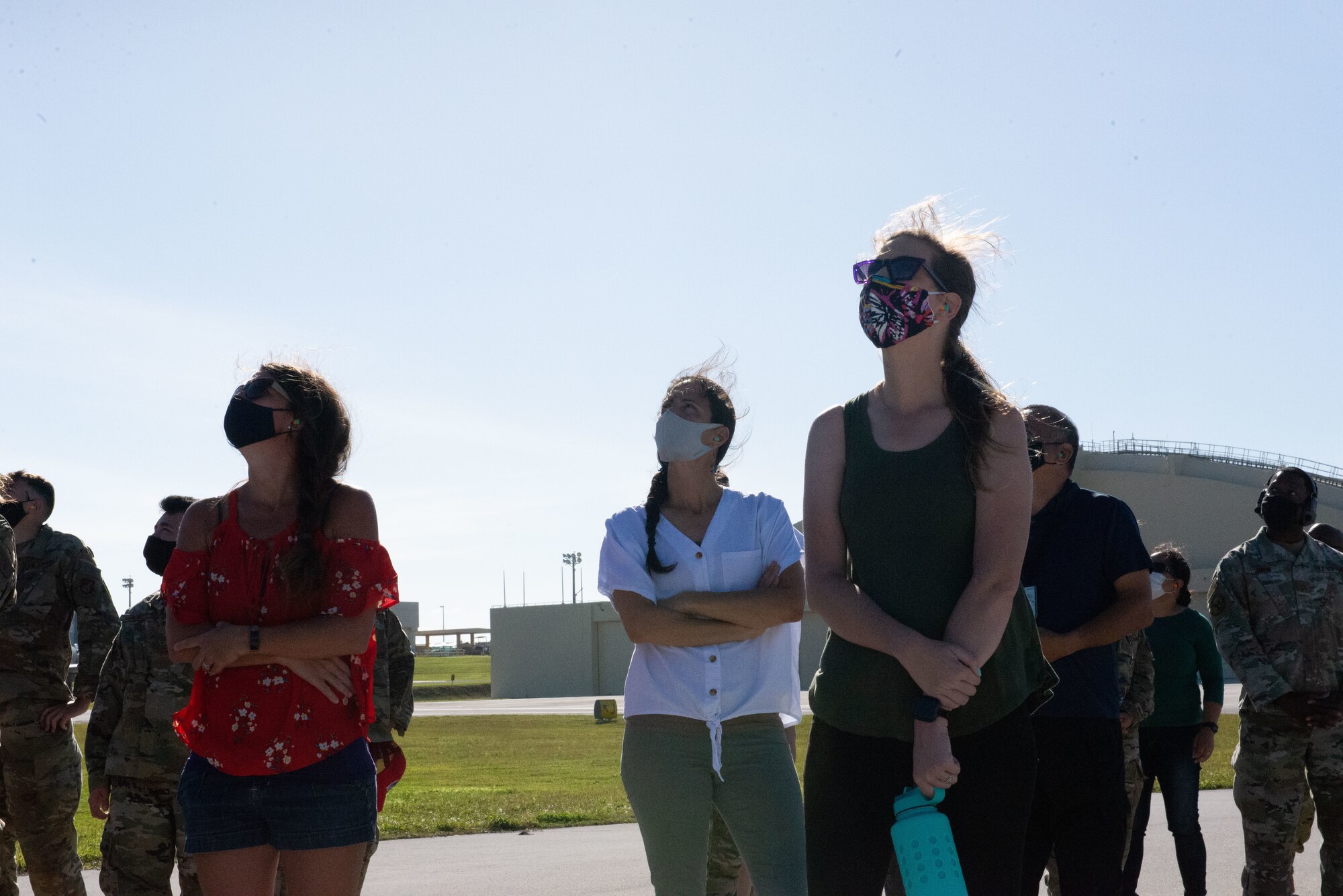 The 36th Contingency Response Group's key spouses observe aircraft take off during a group flight line engagement for Exercise Cope North 2021 at Andersen Air Force Base, Guam, Feb. 10, 2021.