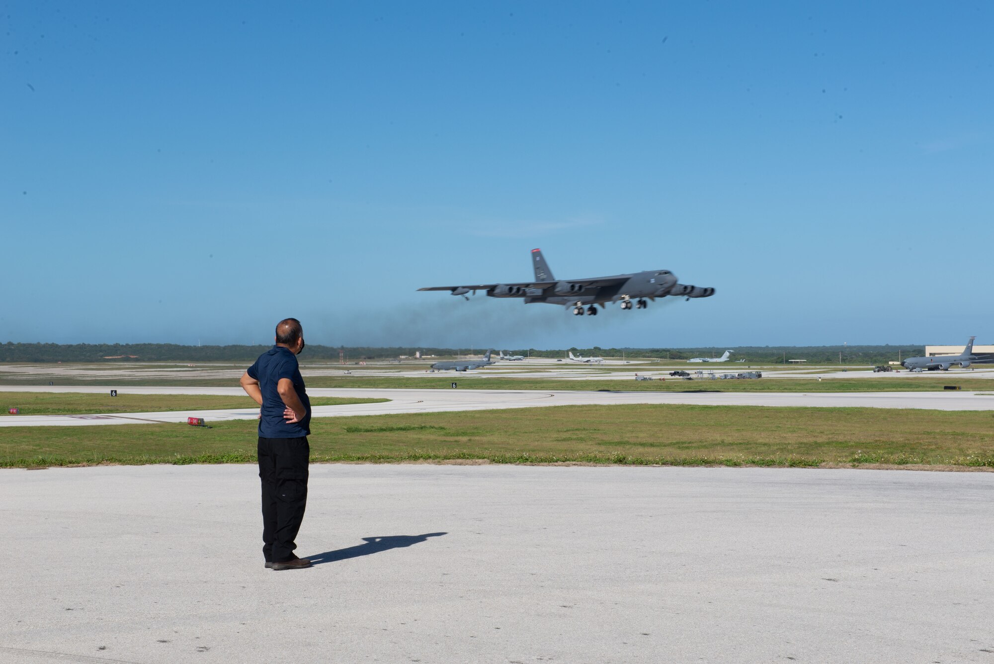 Raymon Perez, 736th Security Forces Squadron, watches a B-52 Stratofortress take off from Andersen Air Force Base, Guam, Feb. 10, 2021.