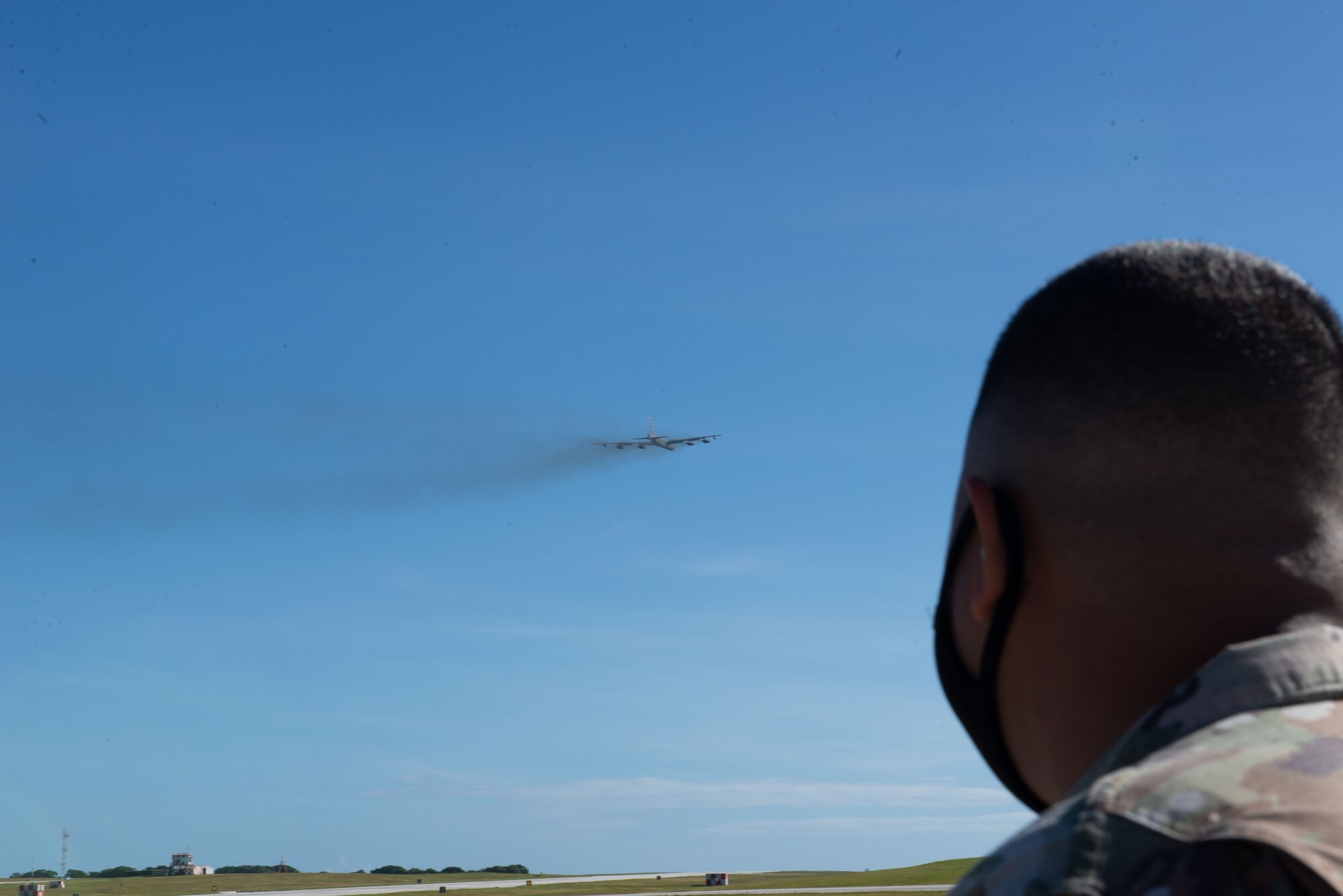 Staff Sergeant Ian Leyco, 36th Contingency Response Group, watches a B-52 Stratofortress take off from Andersen Air Force Base, Guam, Feb. 10, 2021.