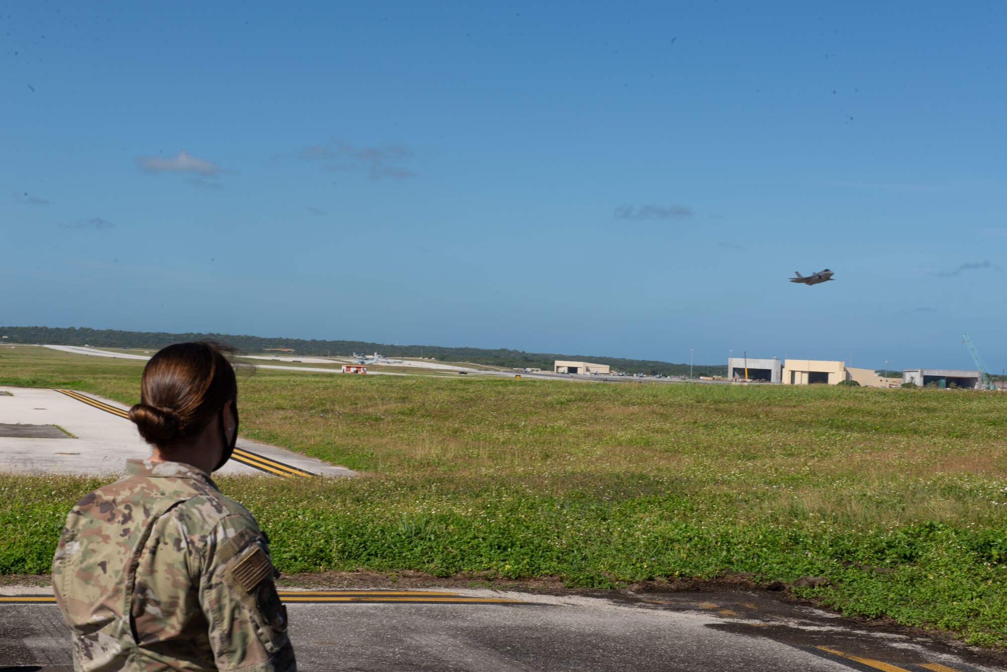 Airmen assigned to the 36th Contingency Response Group watch as a U.S. Air Force F-35A Lightning II assigned to Eielson Air Force Base, Alaska, takes off during a group flight line engagement for Exercise Cope North 2021 at Andersen Air Force Base, Guam, Feb. 10, 2021.