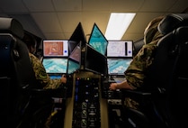 Capt. Sophie, left, 20th Attack Squadron pilot, and Staff Sgt. Timothy, sensor operator, fly a sortie via simulator at Whiteman Air Force Base, Missouri, Nov. 20, 2020. The 20th ATKS is a geographically separated unit under the 432nd Wing/432nd Air Expeditionary Wing. (U.S. Air Force photo by Airman 1st Class William Rio Rosado