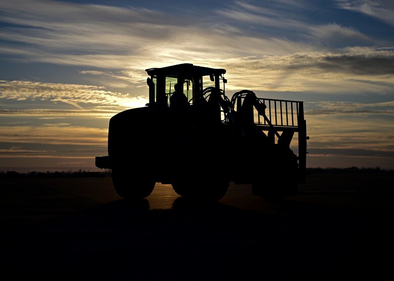 A person operates a forklift