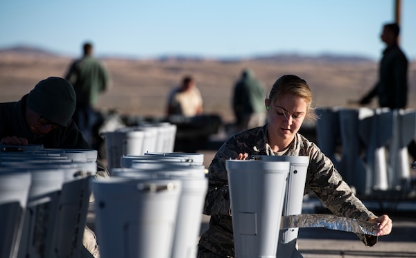 Airman with 57th Munitions Squadron secures door on BSU-33 conical fin assembly for BDU-50 inert bomb at Nellis Air Force Base, Nevada, March 13, 2019 (U.S. Air Force/Perry Aston)