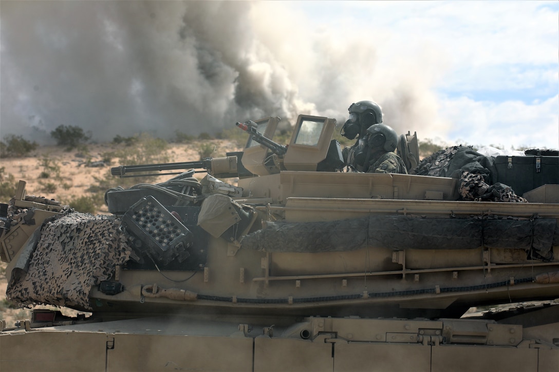Soldiers assigned to 1-252 Armor Regiment, 30th Armored Brigade Combat Team, move to safe location after chemical attack by opposing force in Mojave Desert during 19-09 rotation at National Training Center, on July 12, 2019 (North Carolina National Guard/Leticia Samuels)