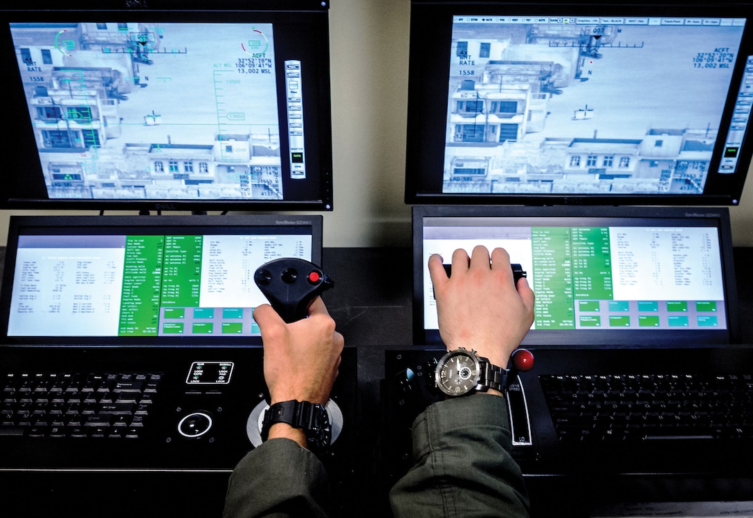 Enlisted pilot student, left, and basic sensor operator course instructor at 558th Flying Training Squadron at Joint Base San Antonio, Texas, conduct training mission utilizing Predator/Reaper Integrated Mission Environment simulator, July 17, 2018 (U.S. Air Force/J.M. Eddins, Jr.)